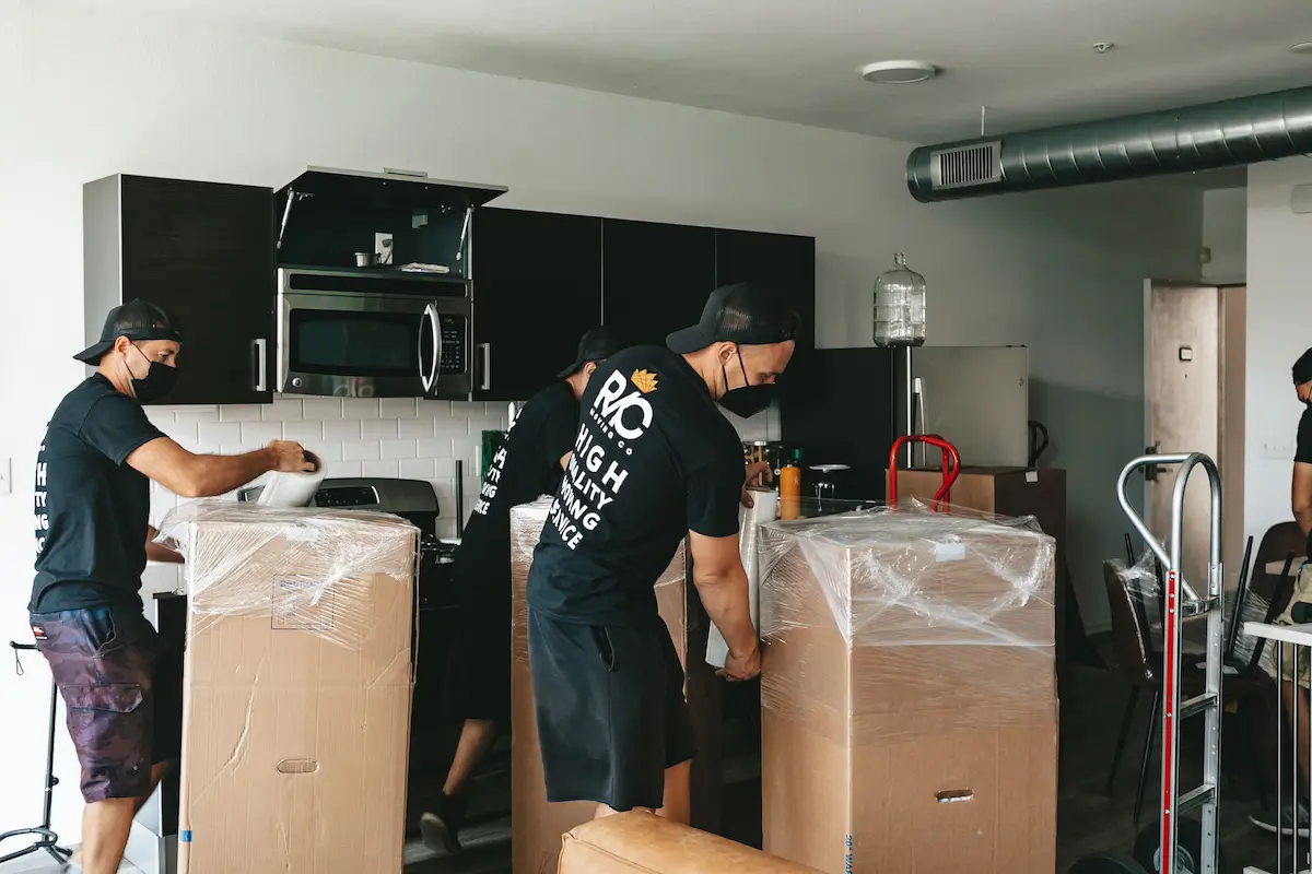 Movewala packers wrapping furniture in a family home